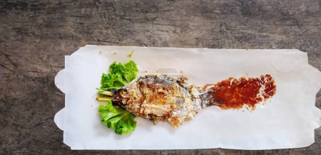 Photo for Thai delight grilled tilapia with Thai herbs and greens - Royalty Free Image