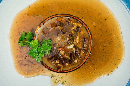 Photo for Steaming hot soup adorned with a medley of wild mushrooms - Royalty Free Image