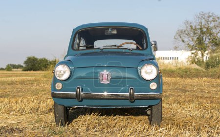 Photo for Reggio Emilia Italy : 2023 01 08 example of Vintage old car Fiat 750 in sugar paper blue color on a sunny day. High quality photo - Royalty Free Image
