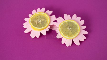 Photo for Pink fun glasses with pieces of  lemon, a healthy lifestyle , minimal concept - Royalty Free Image