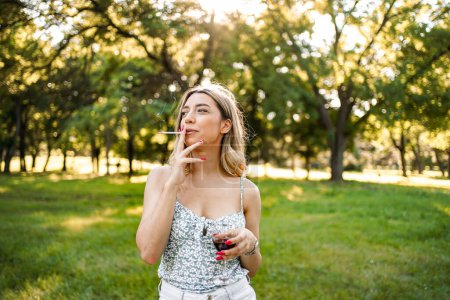 Photo for Portrait of blonde woman with cigar in outdoor. - Royalty Free Image