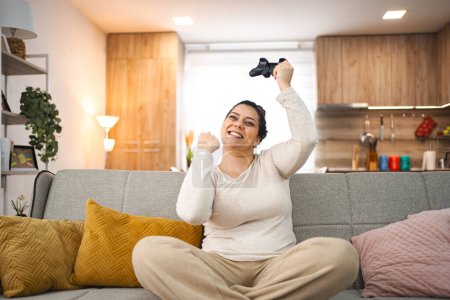 Foto de Mujer divirtiéndose jugando videojuegos en casa. - Imagen libre de derechos