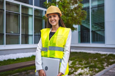 Photo for Smiling female safety engineer outdoors. - Royalty Free Image