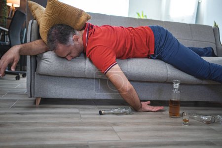 Téléchargez les photos : Homme ivre dormant sur un canapé. - en image libre de droit