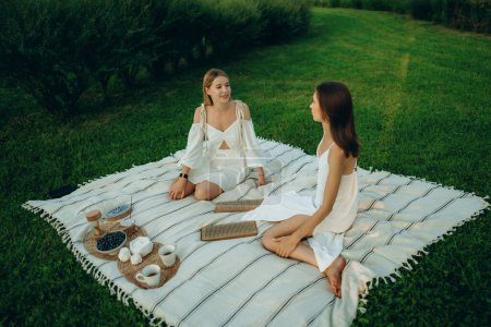 Téléchargez les photos : Deux jeunes femmes méditent et font du yoga dans la nature. Photo de haute qualité - en image libre de droit