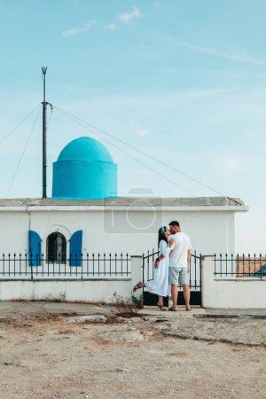 Photo for Happy couple travelers in front of Church of the Prophet Elias Lefkada island Greece - Royalty Free Image