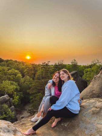 Téléchargez les photos : Heureux couple femmes amis prendre des photos sur coucher de soleil copie espace - en image libre de droit