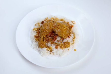 Foto de Vista superior de un plato de arroz blanco caliente cubierto con pollo al curry. Padang Arroz con pollo al curry. - Imagen libre de derechos