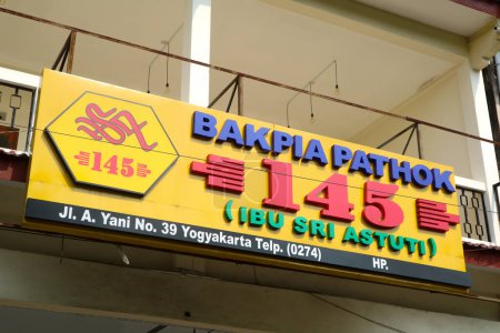 Photo for Yogyakarta, Indonesia - March 20, 2023: Signboard of Bakpia Pathok store around Malioboro tourist area. Bakpia pathok is one of the famous shop that sell javanese food - Royalty Free Image