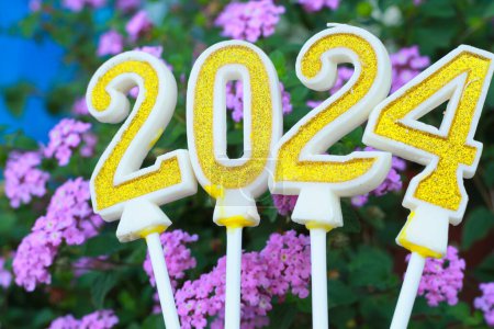 Photo for Golden and glittering candle number 2024 over pink flower with grean leave, 20 24 new year eve background concept - Royalty Free Image