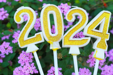 Photo for Golden and glittering candle number 2024 over pink flower with grean leave, 20 24 new year eve background concept - Royalty Free Image