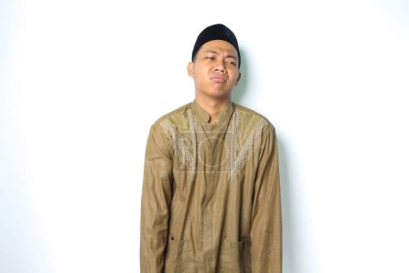 Photo for Attractive asian muslim man wearing islamic clothes look depressed isolated on white background - Royalty Free Image