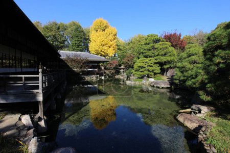 Photo for Rinchitei House, autumn leaves and a pond in Shosei-en Garden, Kyoto, Japan - Royalty Free Image