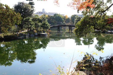 Photo for Ingetsu Pond, Shinsetsu Bridge and autumn leaves in Shosei-en Garden, Kyoto, Japan - Royalty Free Image