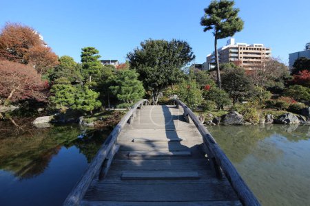 Photo for Ingetsu Pond, Shinsetsu Bridge and autumn leaves in Shosei-en Garden, Kyoto, Japan - Royalty Free Image