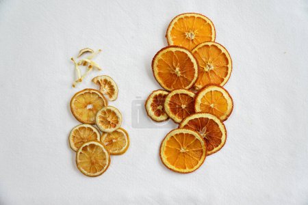 Photo for Artfully arranged dehydrated orange and lemon slices on a crisp white background, showcasing a harmonious blend of citrus colors for culinary charm and visual allure. - Royalty Free Image