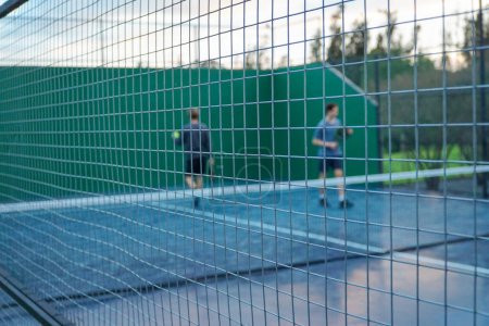 Photo for A couple of people enjoying a game of paddle tennis. - Royalty Free Image