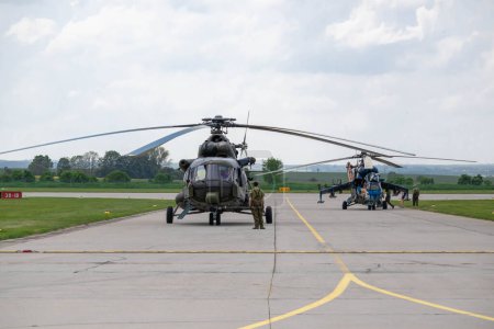 Photo for Pair of czech air force helicopters, Mil Mi-171S and Mil Mi-24 Hind at Caslav air base during air show, May, 2023 - Royalty Free Image