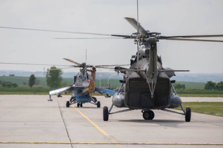 Photo for Pair of czech air force helicopters, Mil Mi-171S and Mil Mi-24 Hind at Caslav air base during air show, May, 2023 - Royalty Free Image