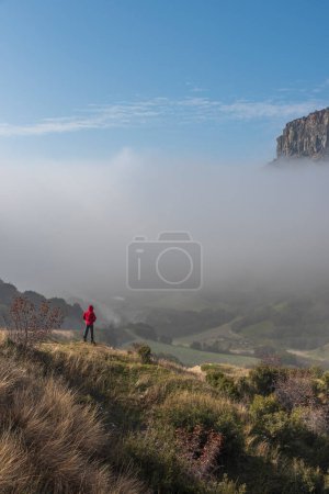 Photo for Kuladocia region, shaped by volcanic remains and erosion over centuries, in the Kula district of Manisa, where a solo person travels on a foggy day. - Royalty Free Image