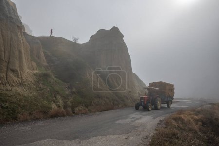 Photo for Kuladocia region, shaped by volcanic remains and erosion over centuries, in the Kula district of Manisa, where a solo person travels on a foggy day. - Royalty Free Image