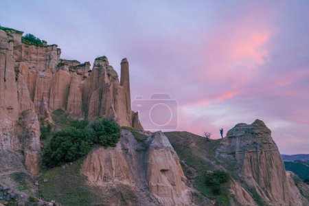 Photo for Fairy chimneys rock forms and sunset colors in the sky in Kula district of Manisa province - Royalty Free Image