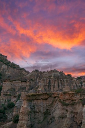 Photo for Fairy chimneys rock forms and sunset colors in the sky in Kula district of Manisa province - Royalty Free Image