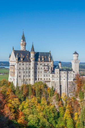 Foto de Castillo de Neuschwanstein uno de los edificios emblemáticos de Alemania es un edificio maravilloso decorado con colores de otoño en el bosque verde natural - Imagen libre de derechos
