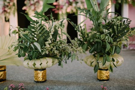 Decorating trees and leaves with small pots for traditional Javanese weddings