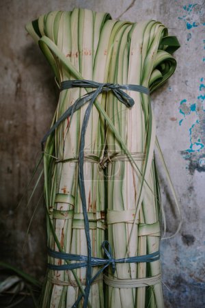 The basic ingredient for ketupat is young coconut leaves which are split into lengths and then made into ketupat