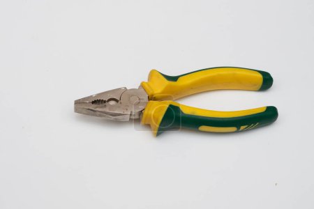 a yellow pair of pliers is placed on a white base