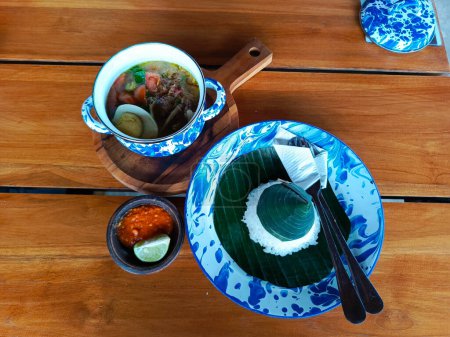 Photo for Soto Lamongan served in vintage tinware, evoking nostalgic village vibes, perfect for showcasing authentic Indonesian culinary heritage - Royalty Free Image