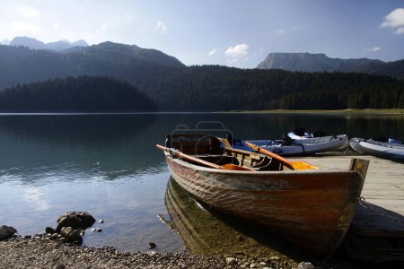 Photo for Rowing boats and canoes at a pier at the Black Lake, Montenegro - Royalty Free Image