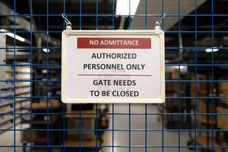 Photo for No admittance sign at a closed gate in a warehouse - Royalty Free Image