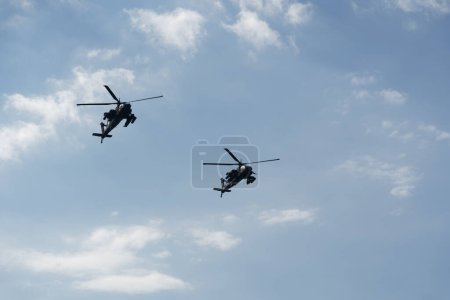 Photo for Thessaloniki, Greece - October 28 2022: Boeing AH-64 attack helicopters on formation during an air show. Greek Air Force Apache flying during the 28 October National Oxi Day parade. - Royalty Free Image