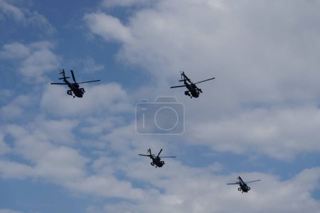 Photo for Thessaloniki, Greece - October 28 2022: Boeing AH-64 attack helicopters on formation during an air show. Greek Air Force Apache flying during the 28 October National Oxi Day parade. - Royalty Free Image