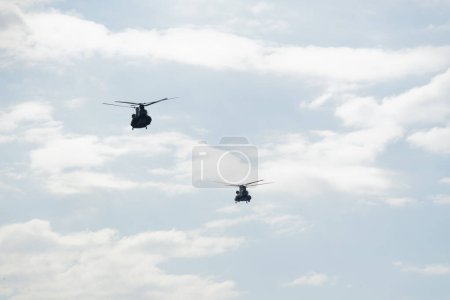 Photo for Thessaloniki, Greece - October 28 2022: Boeing CH-47 Chinook during an air show. Greek Air Force twin-engine lift helicopters flying during the 28 October National Oxi Day parade. - Royalty Free Image