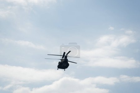 Photo for Thessaloniki, Greece - October 28 2022: Boeing CH-47 Chinook during an air show. Greek Air Force twin-engine lift helicopter flying during the 28 October National Oxi Day parade. - Royalty Free Image