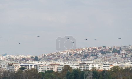 Photo for Thessaloniki, Greece - October 28 2022: Greek Air Force helicopters flying in formation above a city. Air show during the 28 October National Oxi Day parade. - Royalty Free Image