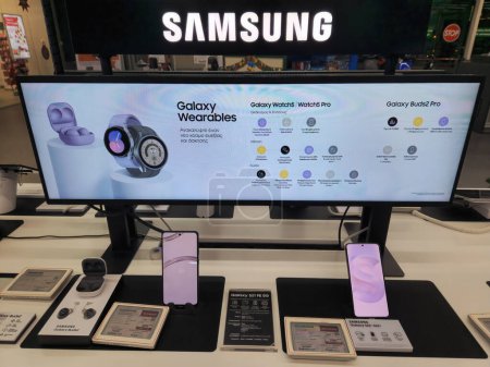 Photo for Thessaloniki, Greece - December 15 2022: Samsung Galaxy gadgets on display inside a shop showcase, including Buds2 headphones, S21 FE and S22 smartphones. - Royalty Free Image