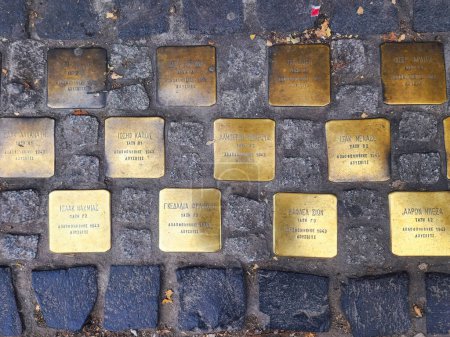 Photo for Thessaloniki, Greece - December 24 2022: Top-down street view of Jewish memorial stolpersteine outside a high school with the names of students murdered in Auschwitz in 1943. - Royalty Free Image