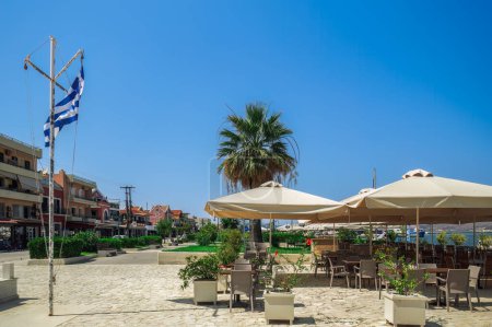 Photo for Empty outdoor seafront cafes with chairs and tables at summer in Lixouri Town on the Ionian Island of Cephalonia Greece. - Royalty Free Image
