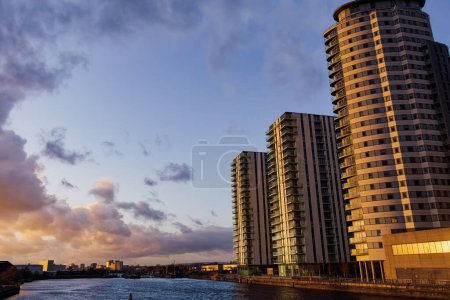 Photo for Manchester, UK - February 20 2020: The Lightbox and The Heart apartment blocks across Salford Quays in MediaCity. - Royalty Free Image