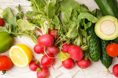 Photo for Radish and other spring vegetables on a wooden background, top view. - Royalty Free Image