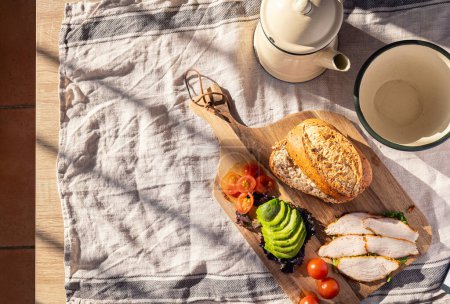 Vital Breakfast: Energy and Freshness, bread, tomato, avocado, chicken. Top view, horizontal, natural light