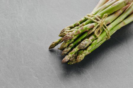 Photo for Asparagus on dark background, top view. Copy space. Fresh healthy vegetable - Royalty Free Image