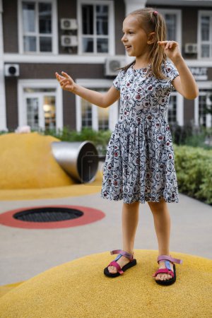 Photo for Child playing on playground in the city. Girl running. Preschooler having fun outdoors in summer. Developing coordination - Royalty Free Image