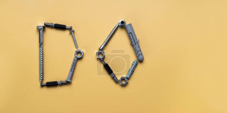 Photo for Sign Do, frame with copy space made of bolts, screws. Banner on yellow plain background - Royalty Free Image