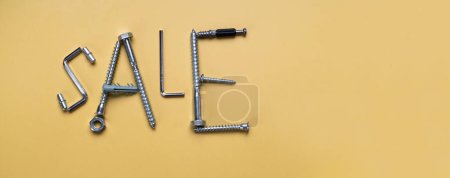 Photo for Words Sale, frame with copy space made of bolts, screws. Banner on yellow plain background - Royalty Free Image