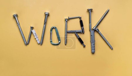 Photo for Sign Work, frame with copy space made of bolts, screws. Banner on yellow plain background - Royalty Free Image
